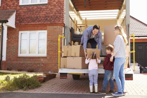 Moving team handling furniture safely with protective equipment