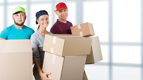Careful loading of household items into a removals van