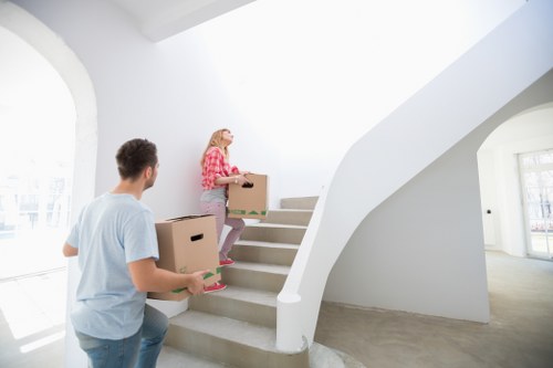 Removalists handling stairs and access in an East London home