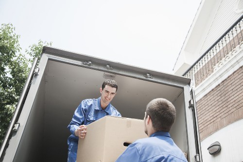 Local movers loading items into a removals van in East London